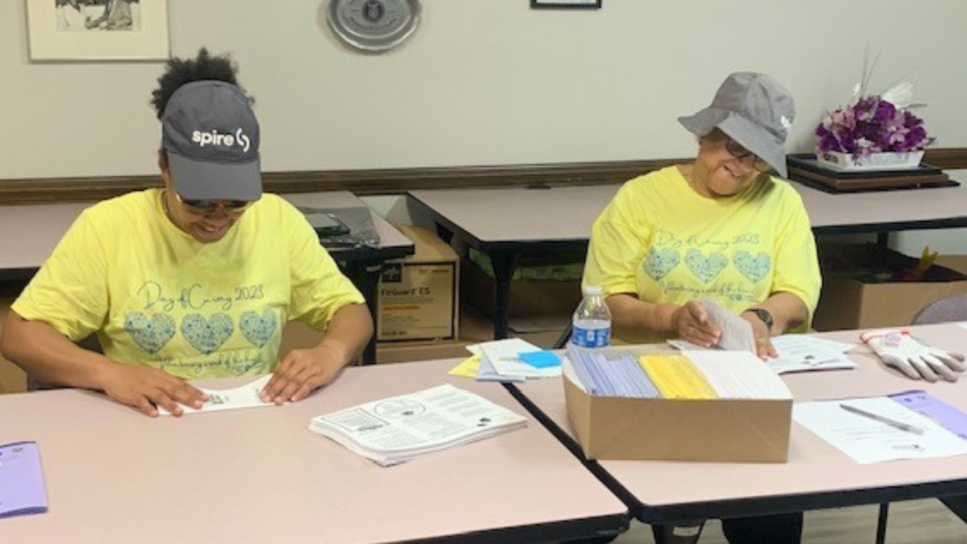 Image of two female Spire employees volunteering indoors at a shelter