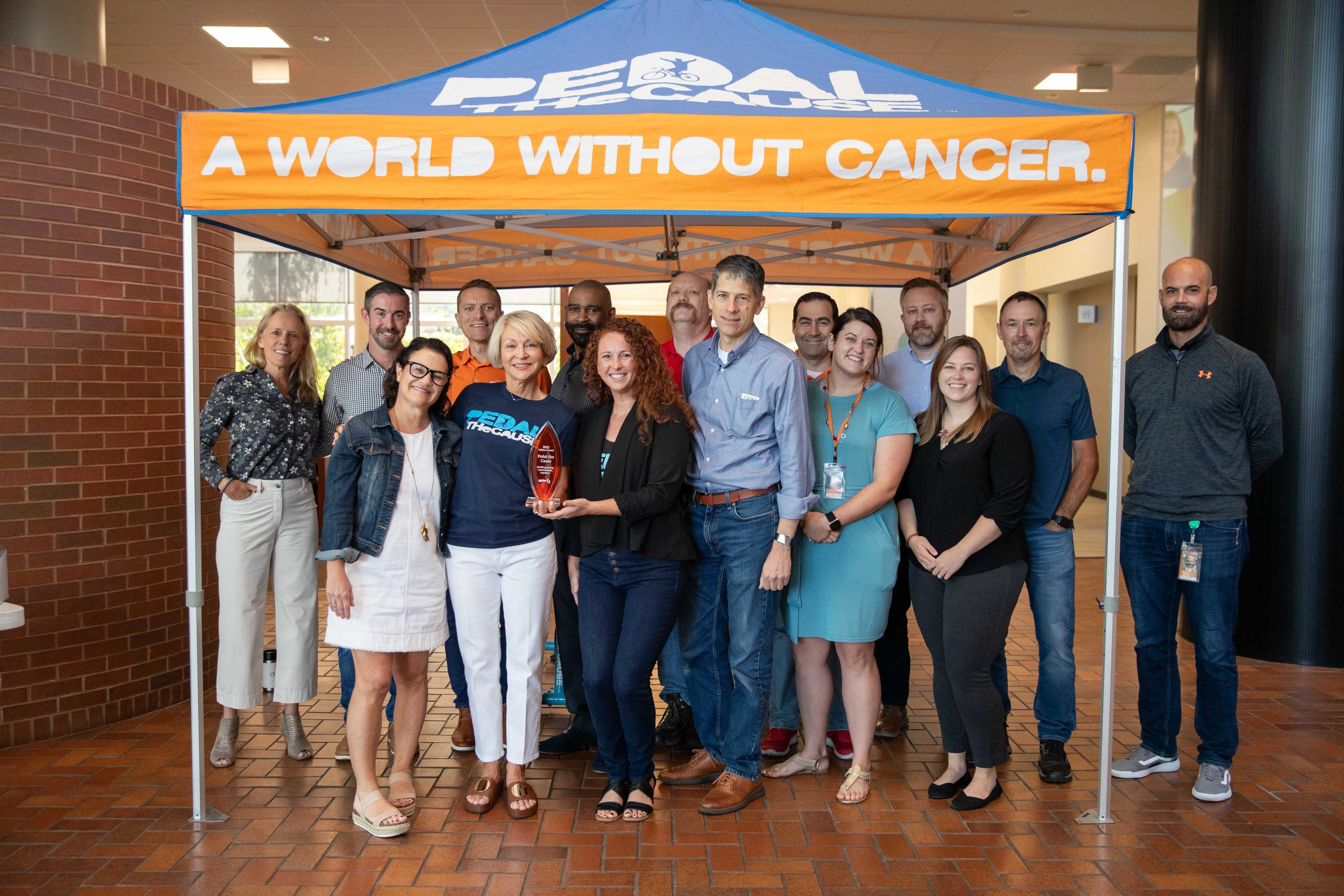 Image of Spire employees and Pedal the Cause employees in Spire's lobby