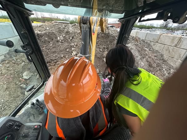 Image of student and Spire employee working on equipment