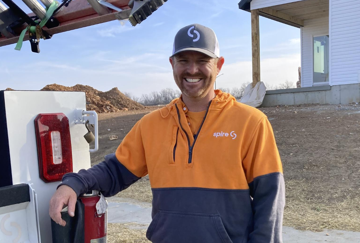 Image of Spire employee in front of a construction site