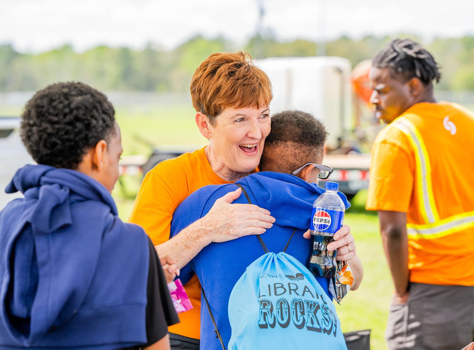 Spire employee hugging attendee at event