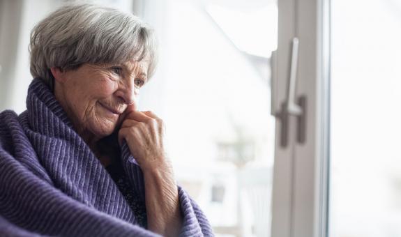 Woman warming up with blanket