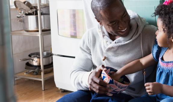 Father and daughter sitting on floor