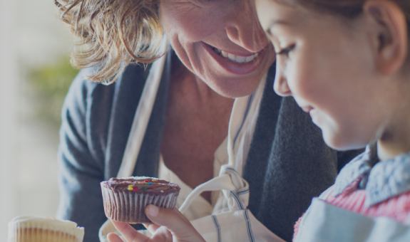 mother and daughter sharing cupcakes