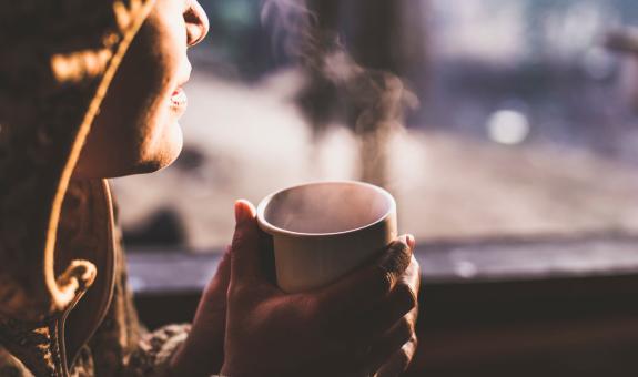 Woman holding cup of coffee