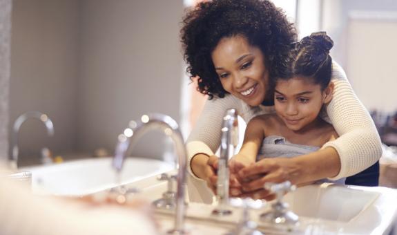 Mom and daughter washing hands