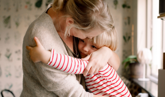 Mother giving son a hug