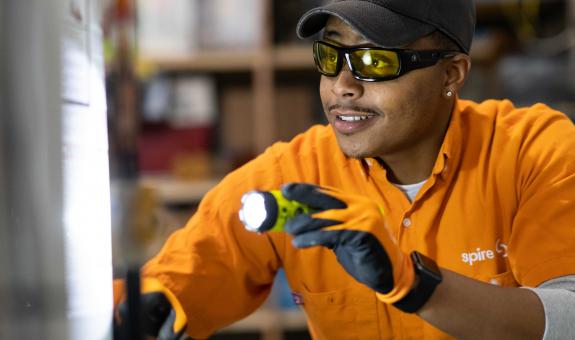 Spire employee inspecting a furnace