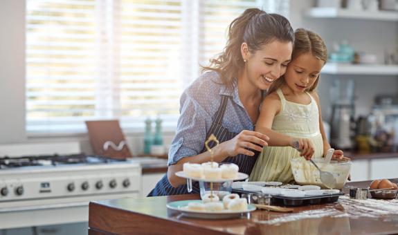 Mother and daughter baking a cake