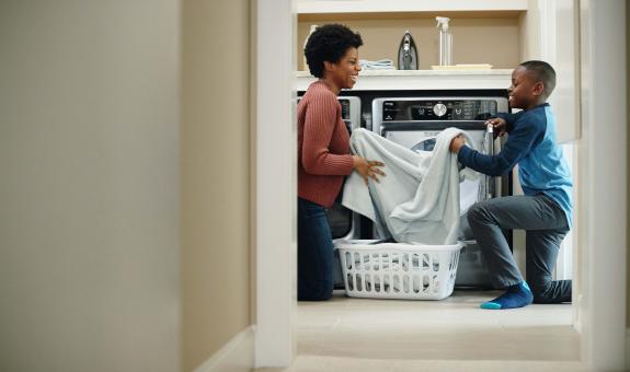 Mother and son folding laundry