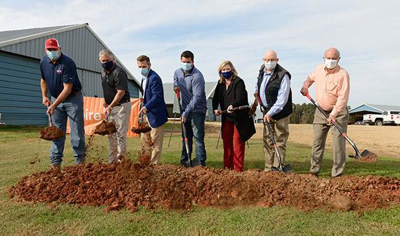 Image of elected officials breaking ground on a farm