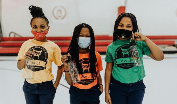 Image of students wearing masks and holding water bottles