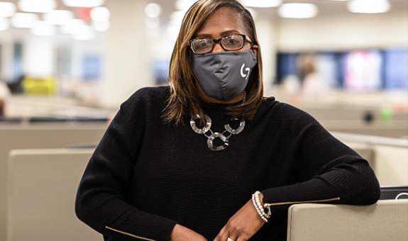 Spire employee in office with mask