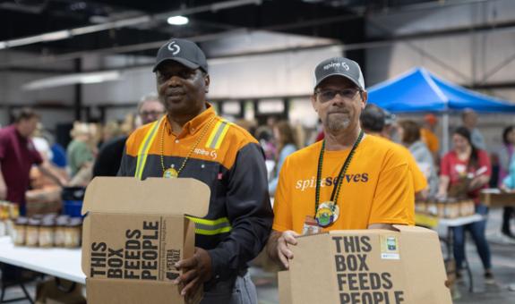 Image of two Spire employees in Mobile, AL volunteering at local food bank