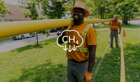 Image of Spire employee carrying pipes