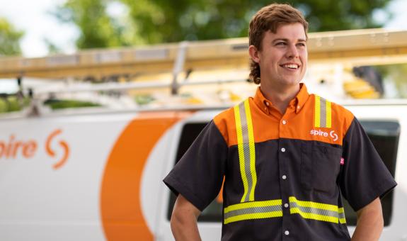 Image of spire co-op student standing in front of a Spire service van