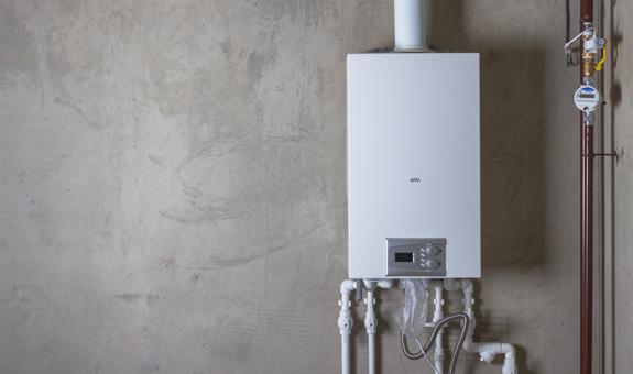 Image of tankless water heater on a gray concrete wall