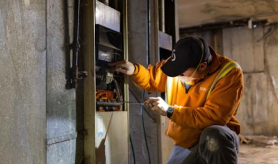 Image of technician working on a furnace