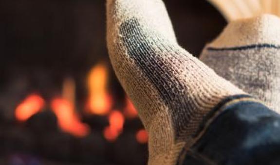 Feet in front of fireplace