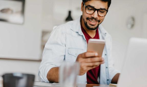 Image of man looking at his phone