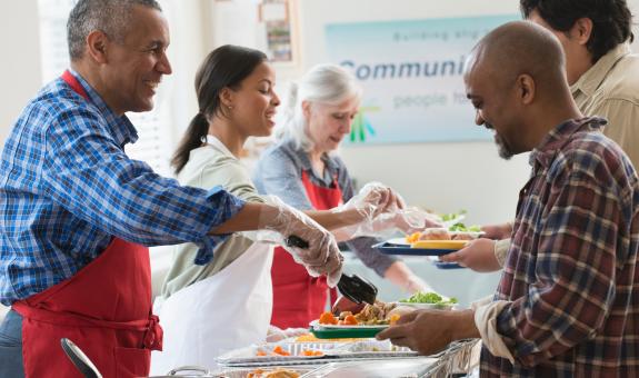Image of people volunteering in a soup kitchen