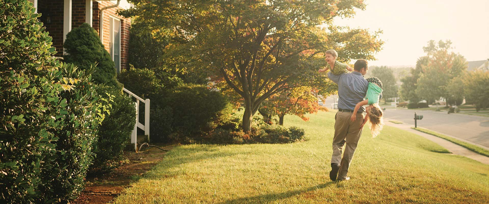 Father and kids playing in yard