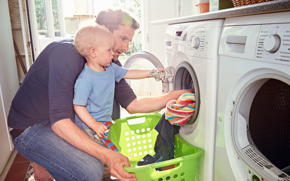 Father and son unloading laundry