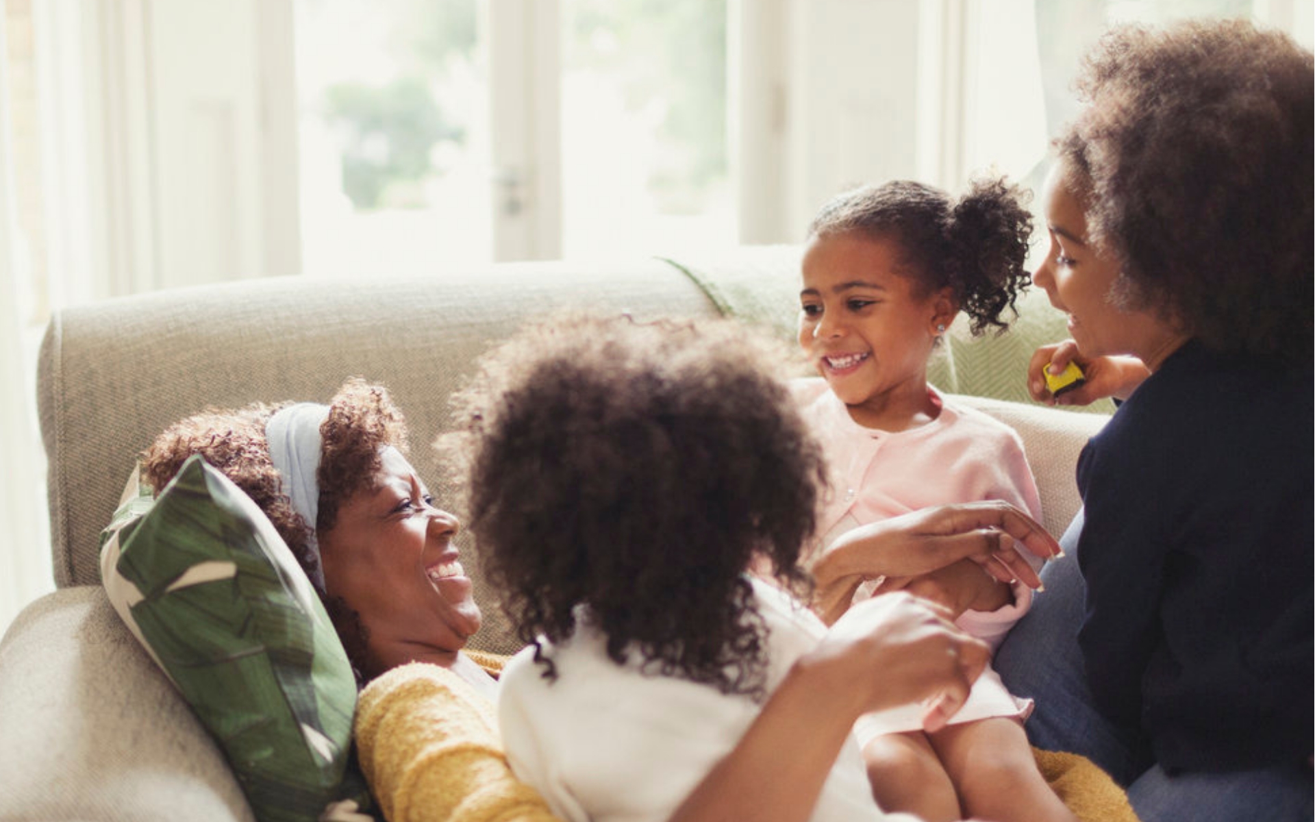 Family snuggling on couch
