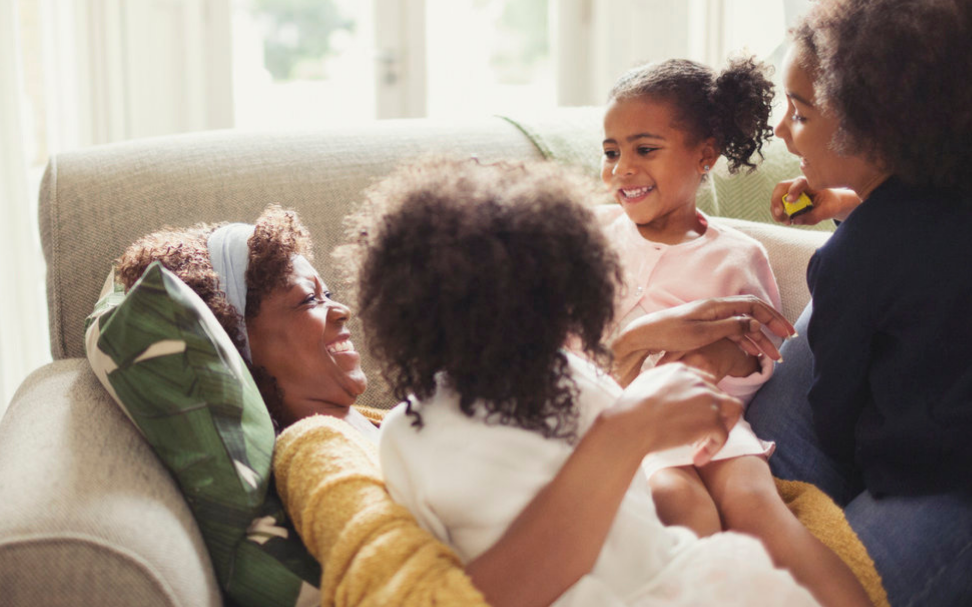 Family snuggling on couch