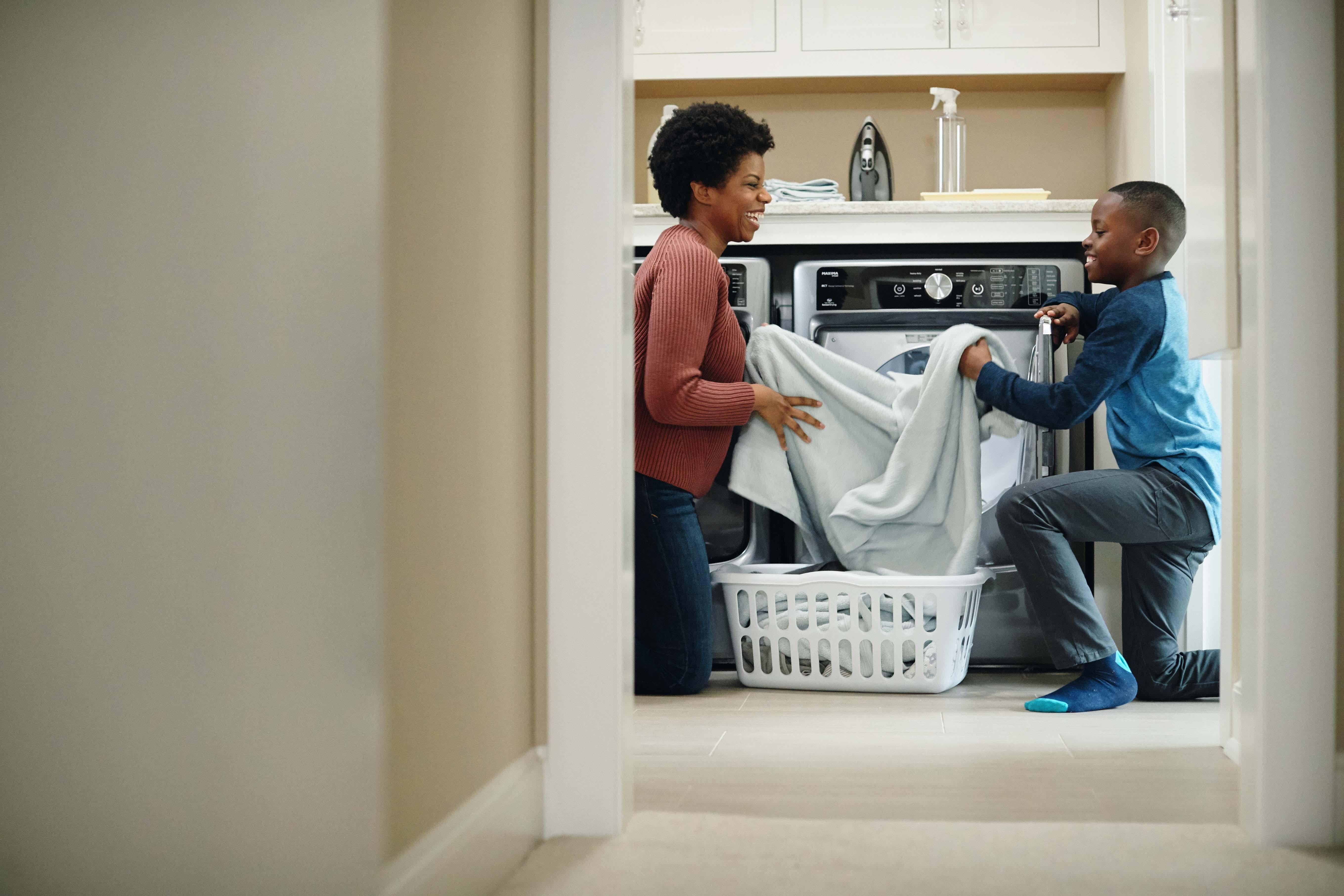 Mother and son folding laundry