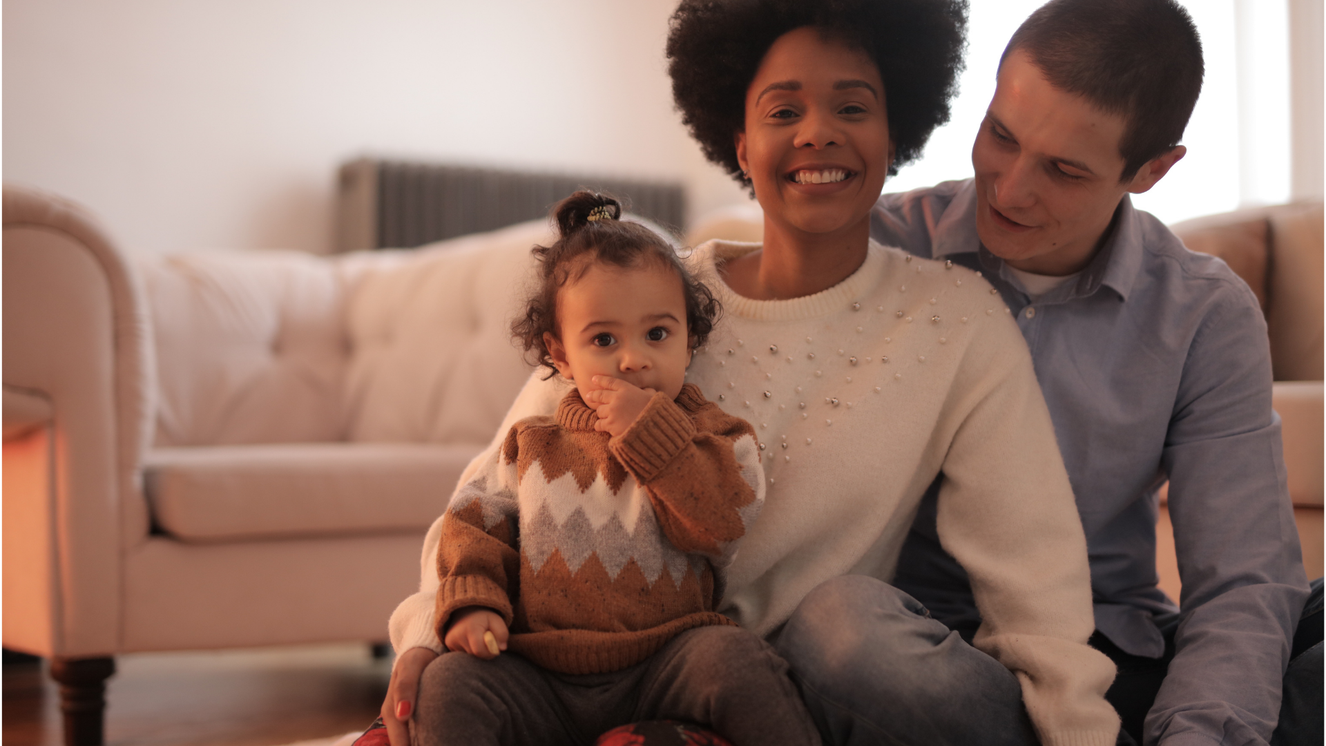 Family snuggling in living room