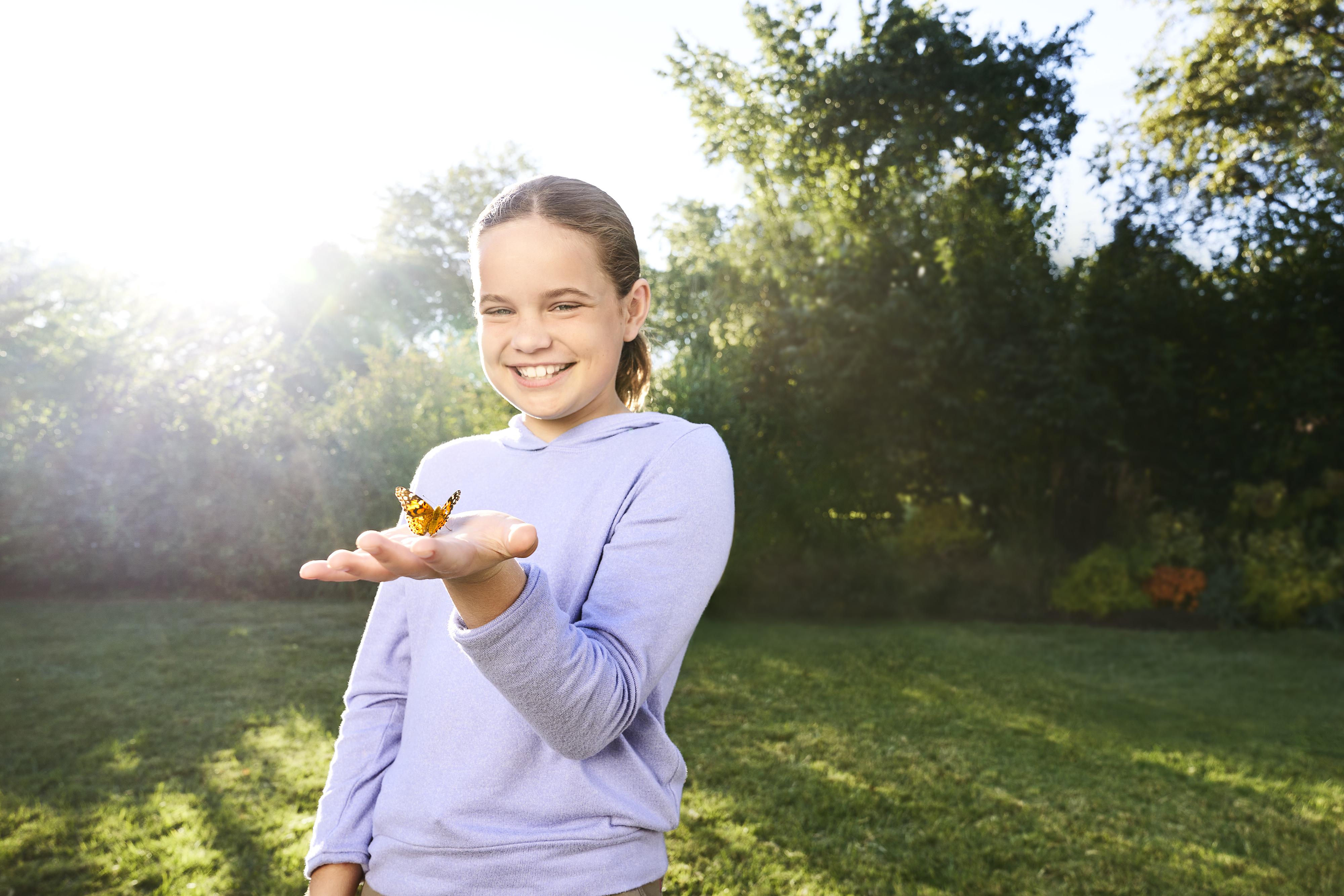 Image of: Little girl holding butterfly