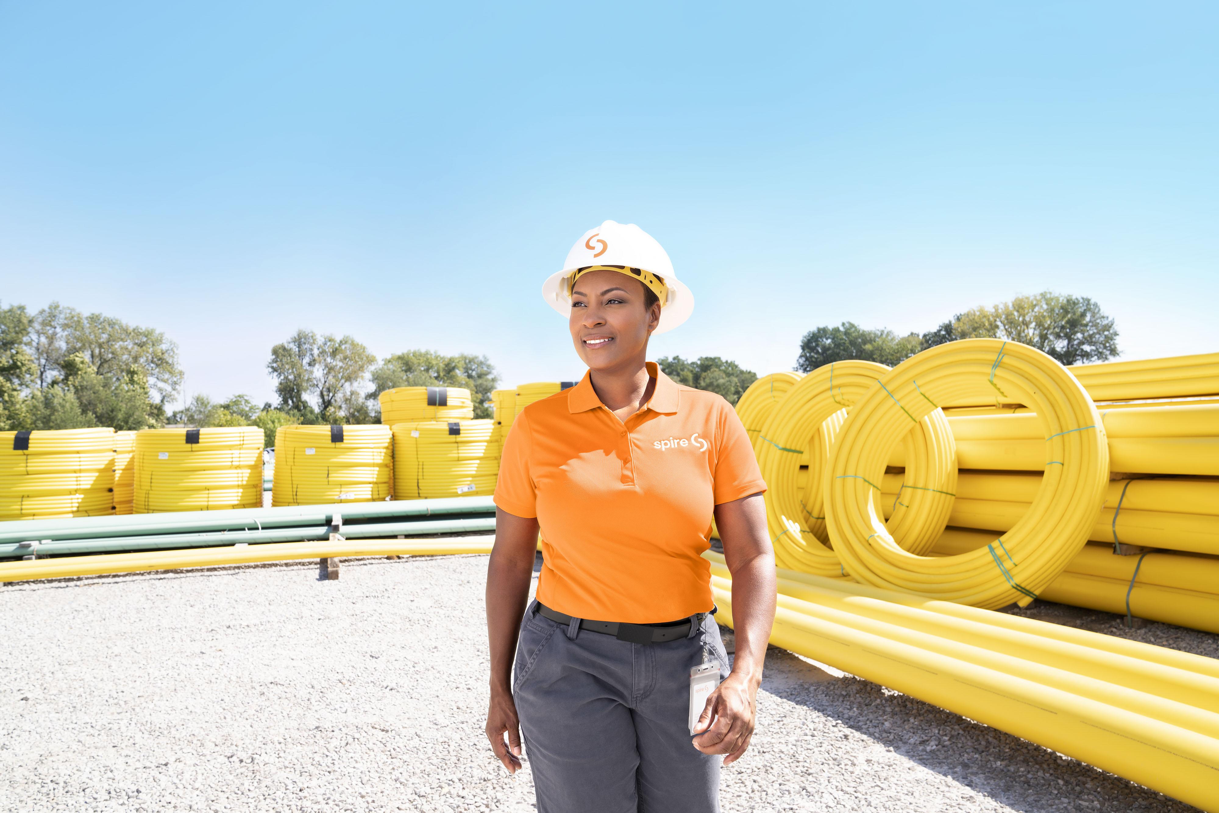 Image of: Woman standing near yellow pipes