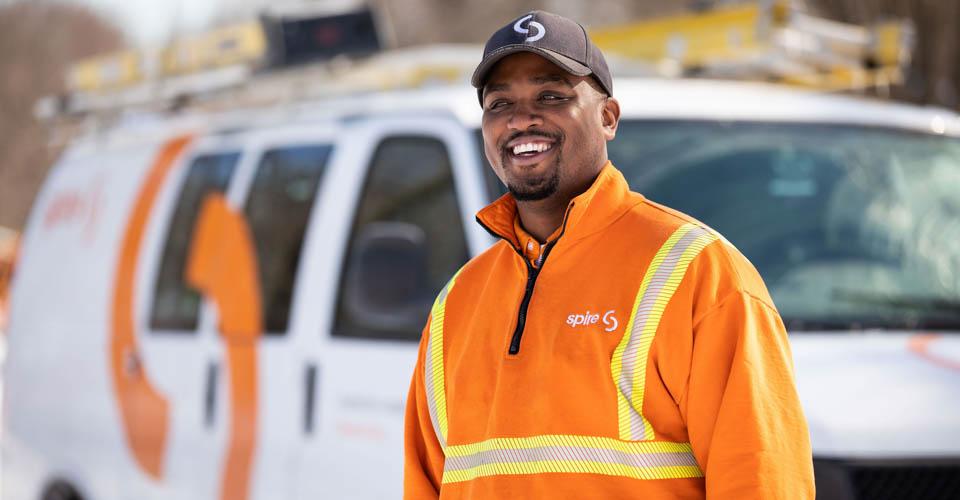 Image of Spire service technician in front of Spire service van