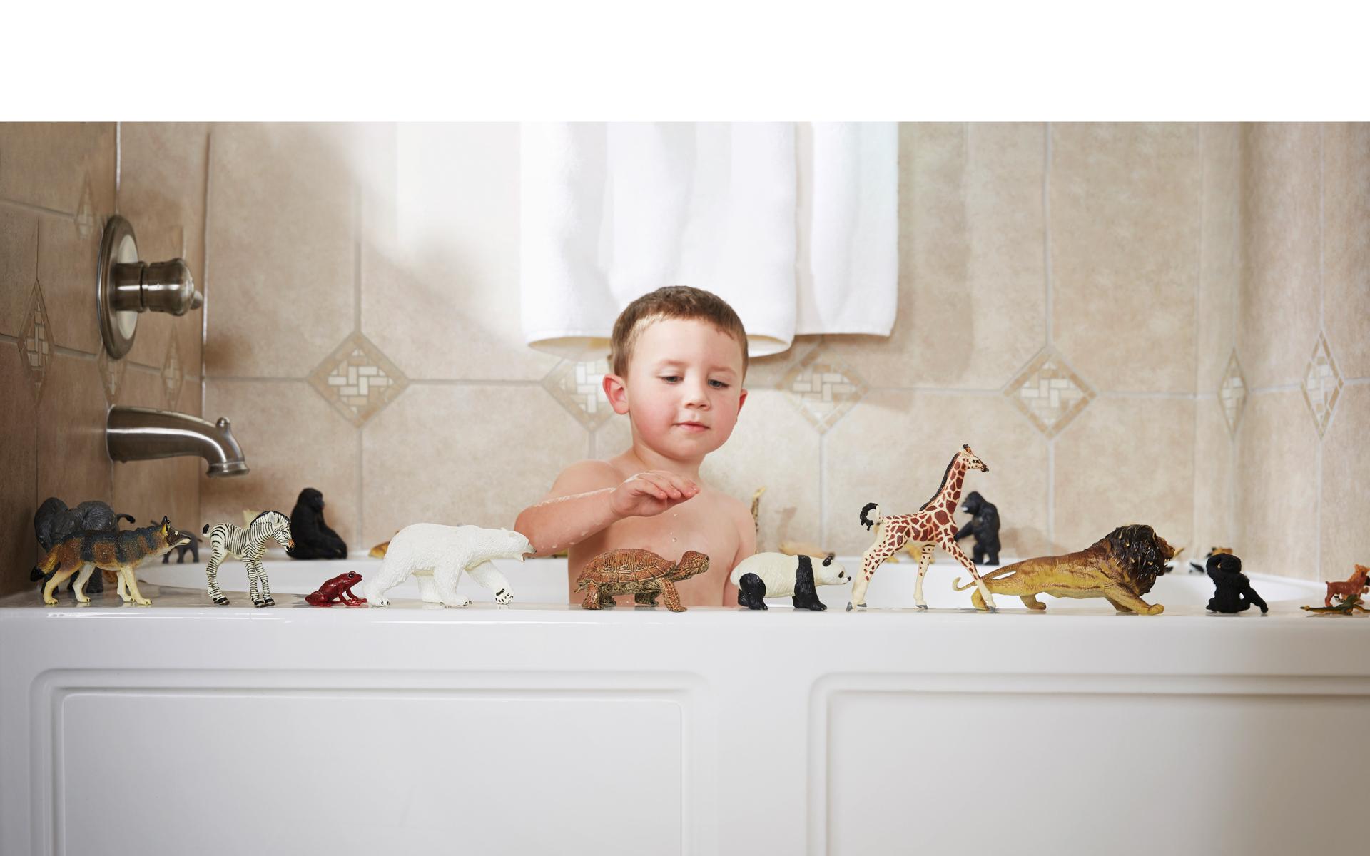 Image of small child playing with zoo toys