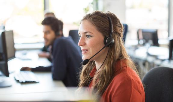 Image of woman taking a phone call in a call center