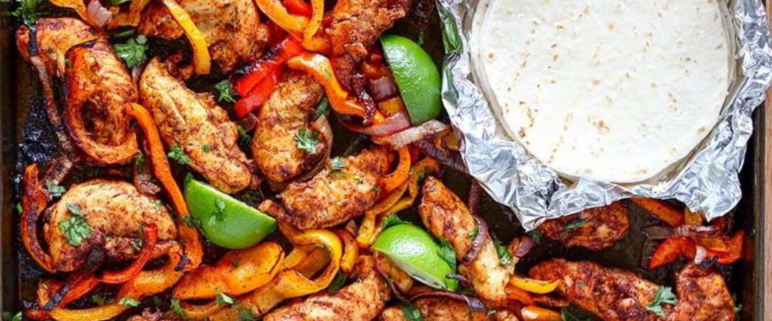 image of fajitas and a tortilla on a sheet pan