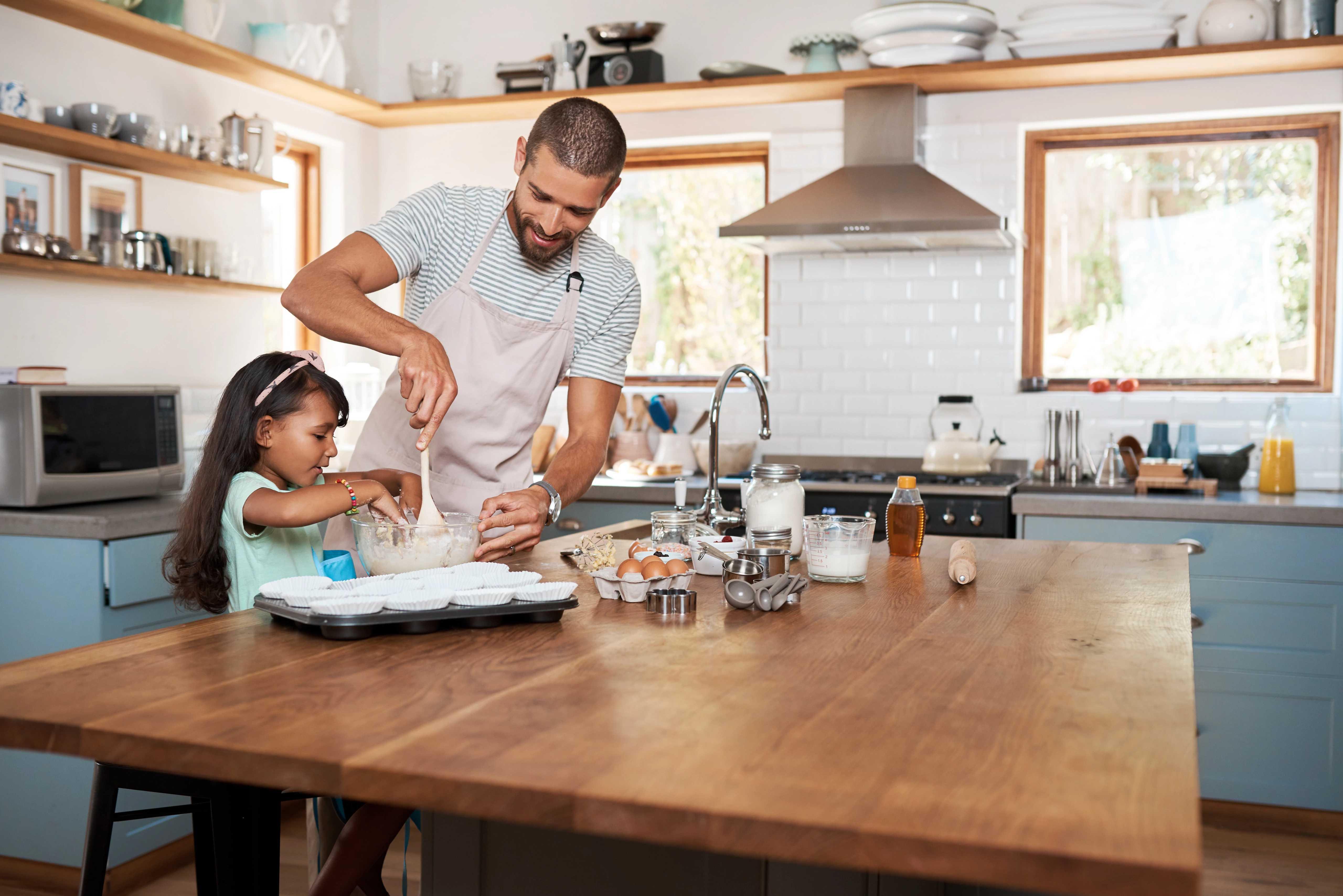 Image of father and daughter decorating eggs