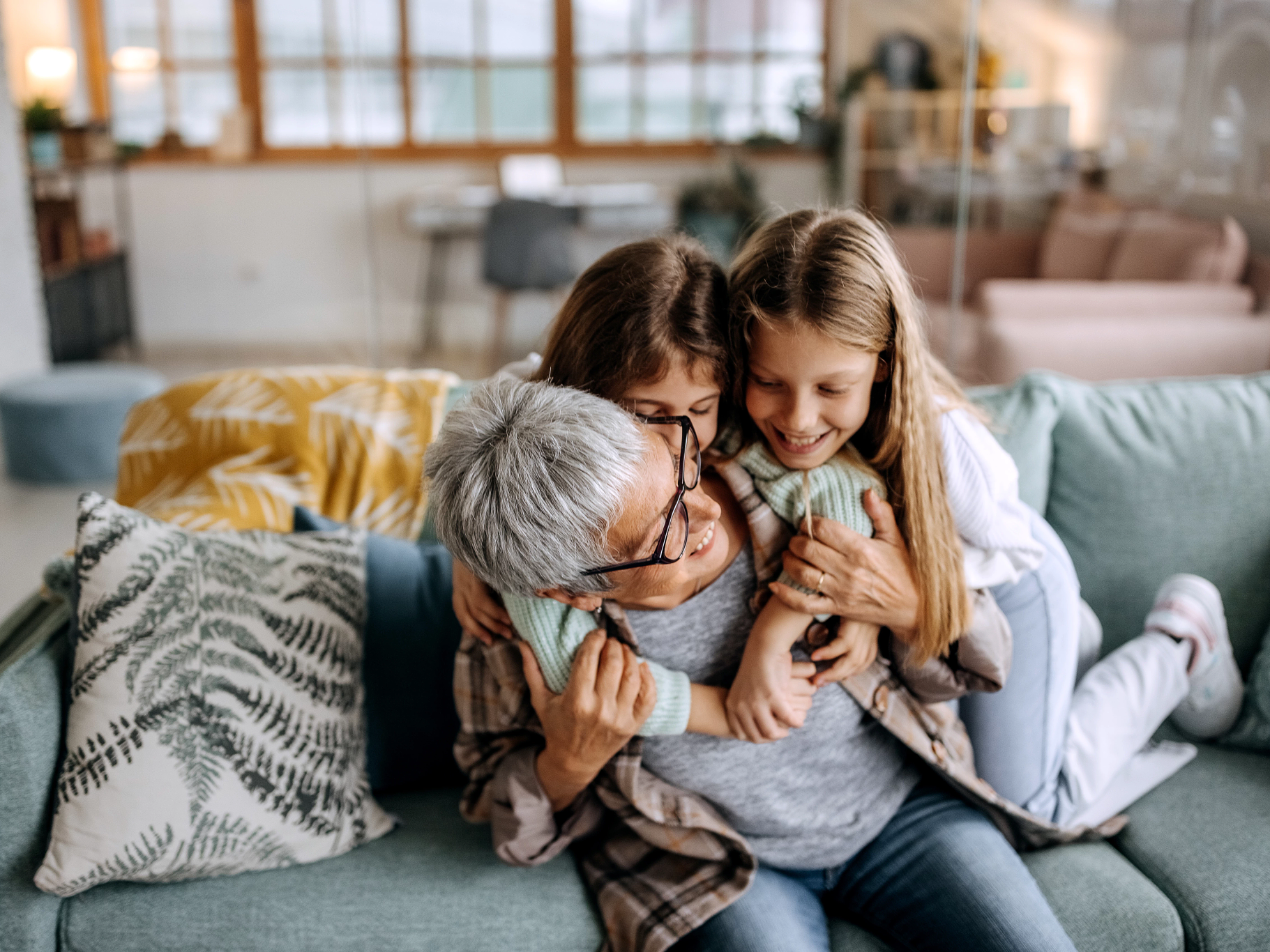 image of a grandmother and two granddaughters on the couch