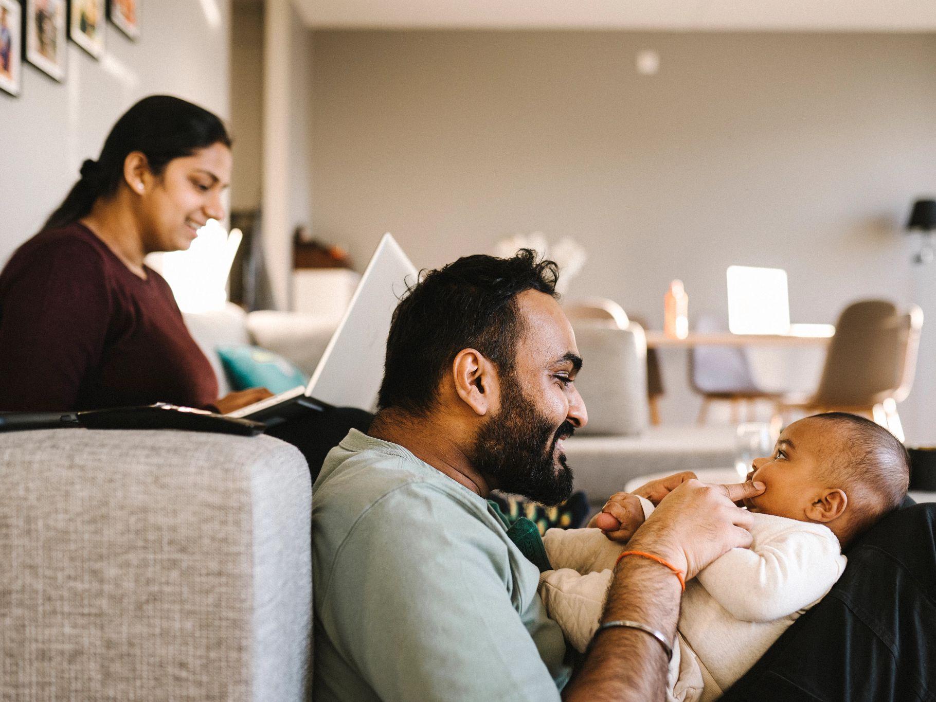 Image of family sitting together on couch