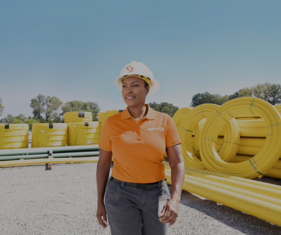 Image of: Woman standing near yellow pipes