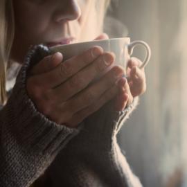 Woman holding cup of coffee